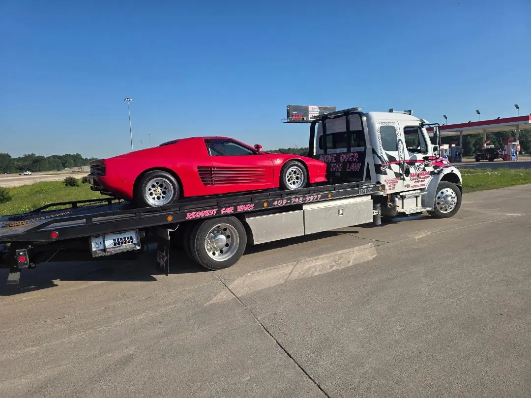 Car Wars Towing flatbed safely transporting a red Ferrari Testarossa near Orange, TX