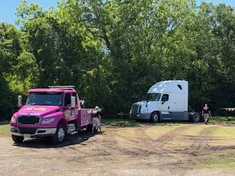 Pink Car Wars wrecker recovering a semi-truck tractor in Orange, TX